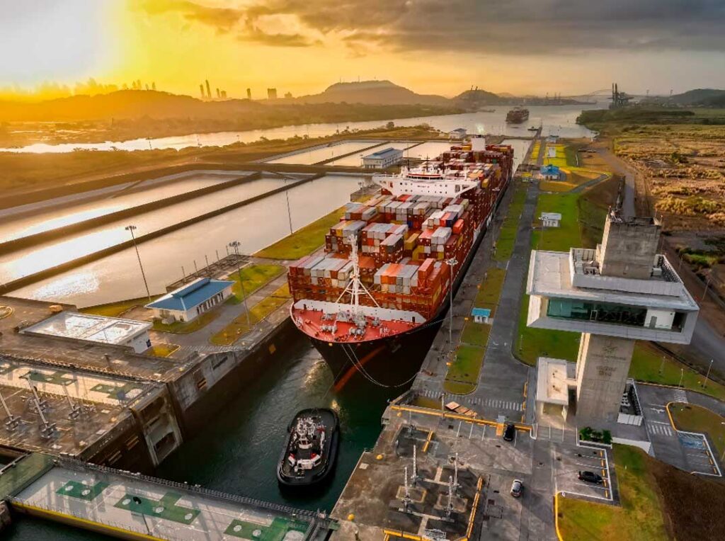 Buque portacontenedores cruzando las esclusas del Canal de Panamá al atardecer